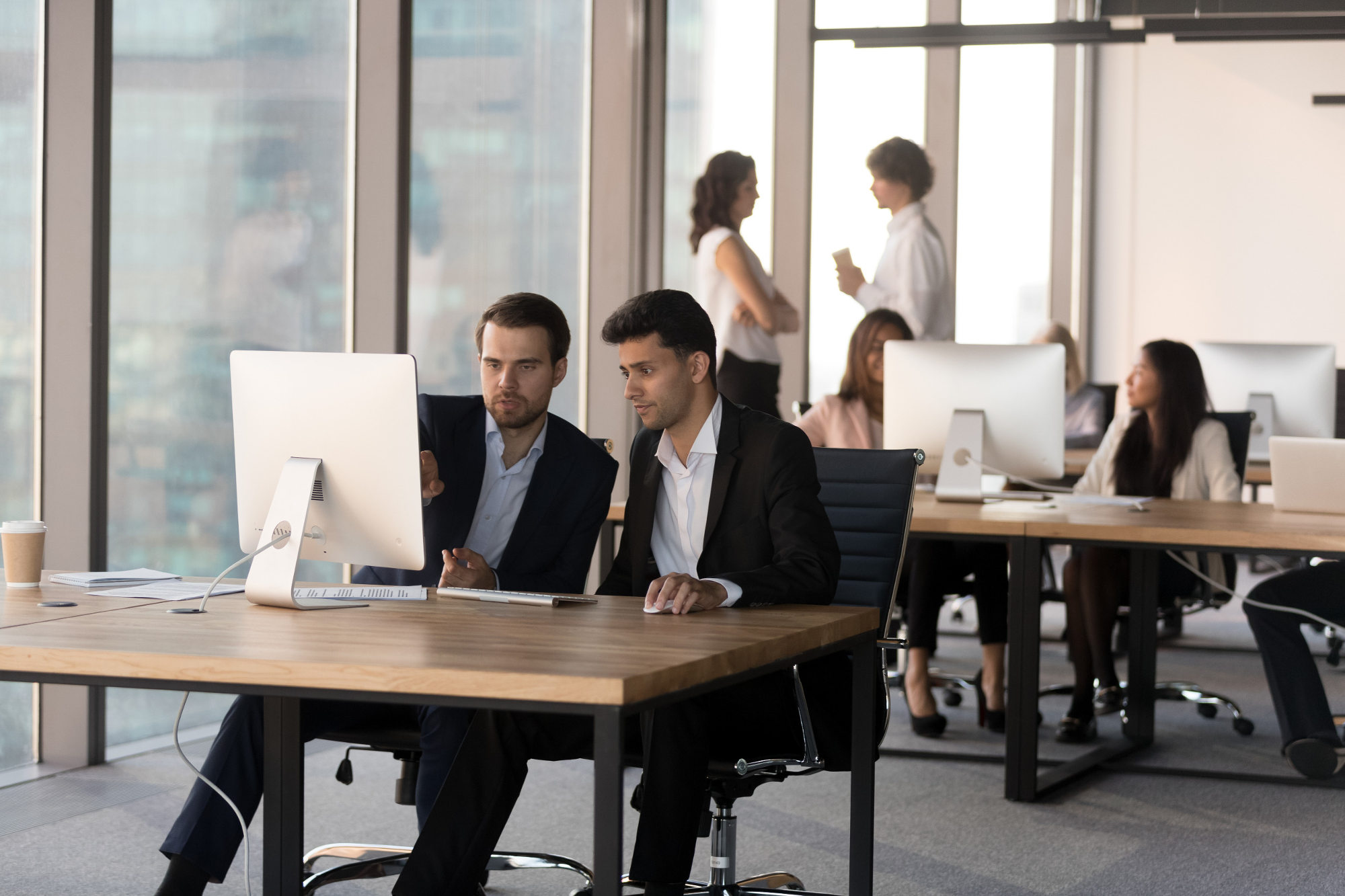 Businessmen working together at same table discussing a project