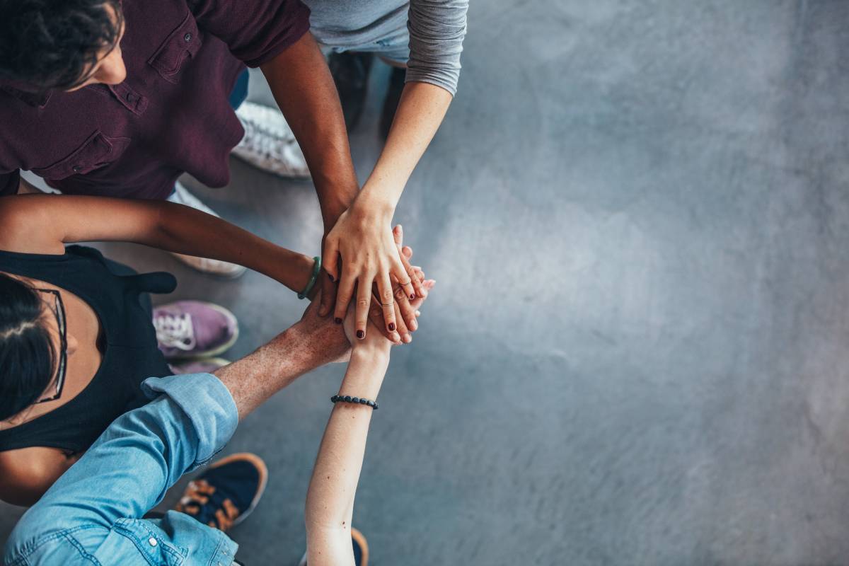 A group of people with their hands together