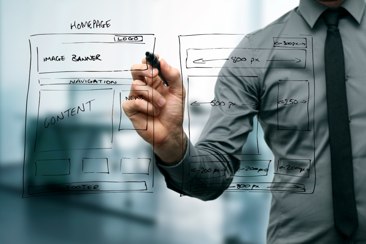 A man drawing a wireframe website mockup