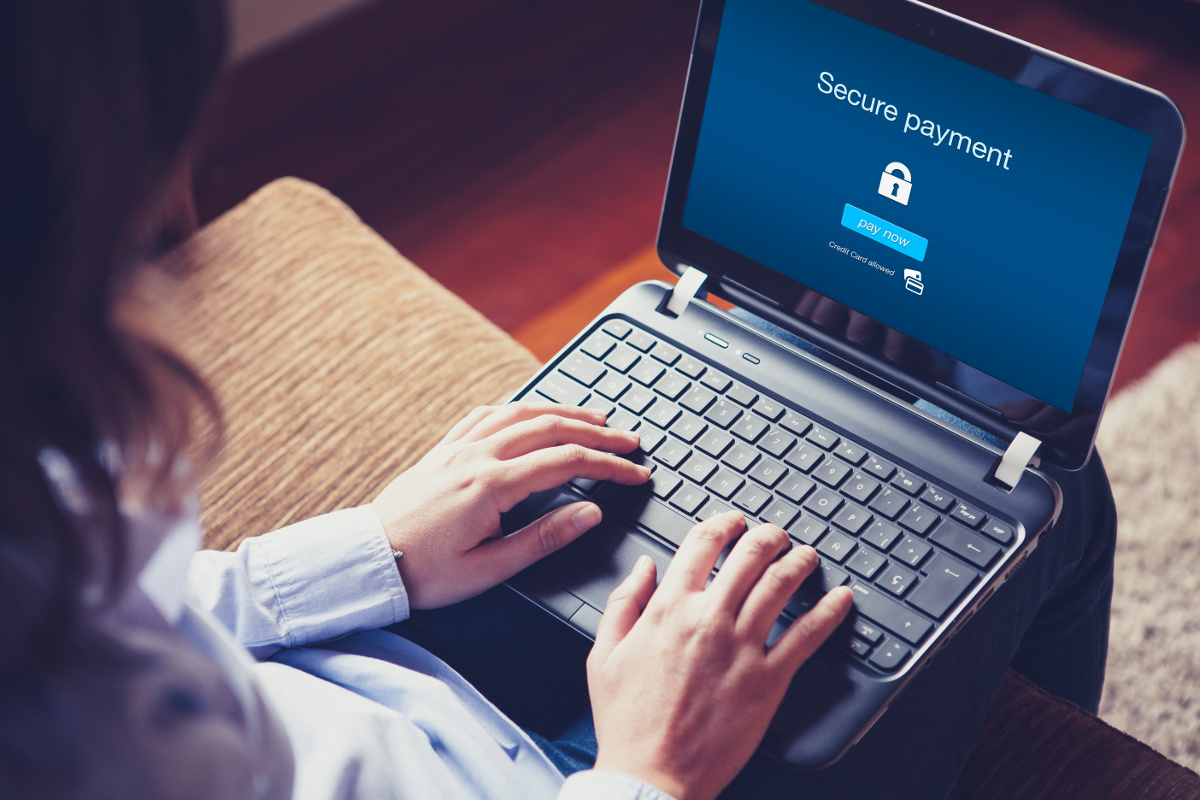 Close Up of Woman Using Laptop with Secure Payment Message on Screen